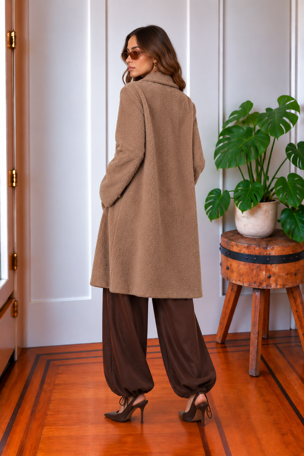 Back view of the Blythe long tan sweater jacket featuring a soft fuzzy texture and relaxed longline silhouette.