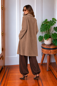 Back view of the Blythe long tan sweater jacket featuring a soft fuzzy texture and relaxed longline silhouette.