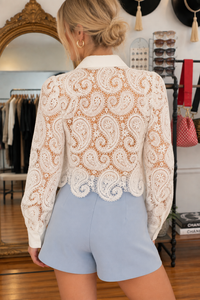 Back view of Della white paisley lace blouse with sheer long sleeves and scalloped lace hem