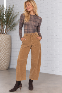 Front view of a model wearing the Harper Corduroy Cropped Barrel Pants in fawn, featuring textured corduroy fabric, high-rise waist, front patch pockets, relaxed barrel-leg silhouette, and cropped length.