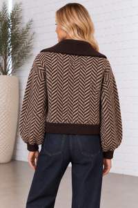 Back view of the Herringbone Zip Front Cardigan in chocolate brown and taupe, featuring an allover herringbone pattern, oversized collar, balloon sleeves, and contrasting ribbed hem.