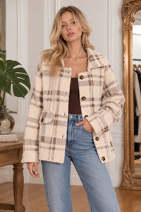 Front view of the Lola Plaid Coat in cream and brown, featuring a soft fuzzy texture, relaxed oversized fit, collared neckline, button-front closure, and classic plaid pattern.
