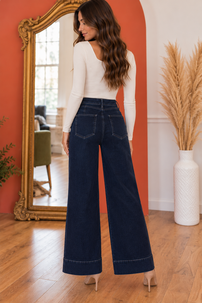 Back view of the Maya high-rise wide-leg jeans in dark indigo denim, featuring back darts, classic back pockets, a relaxed wide-leg silhouette, and wide stitched hems.