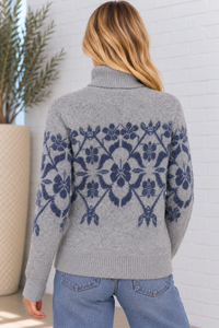 Back view of the Provence Floral Jacquard Sweater in grey navy, showcasing the navy blue floral jacquard design across the back and sleeves, ribbed turtleneck, and cozy textured knit.