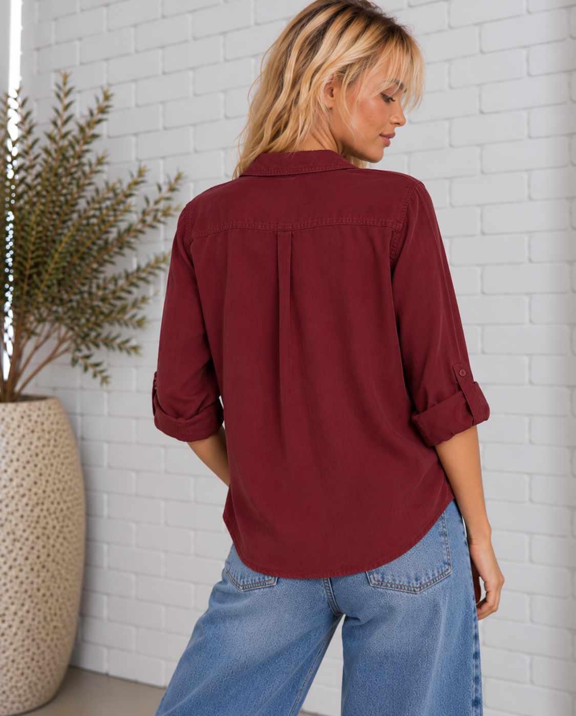 Back view of the Talma Shirt in Bordeaux, featuring a relaxed fit, back yoke, adjustable roll-tab sleeves, and curved shirttail hem.
