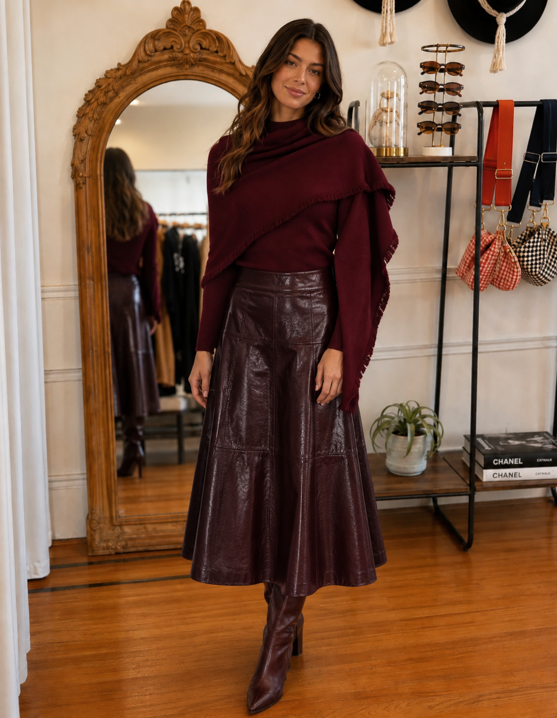 Model wearing a burgundy scarf sweater with fringe detail and matching burgundy midi skirt