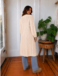 Close-up of Iggy cream hand-knit cardigan showing chunky textured stitching and ribbed trim