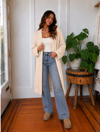 Front view of Iggy cream hand-knit long cardigan with textured knit and open front