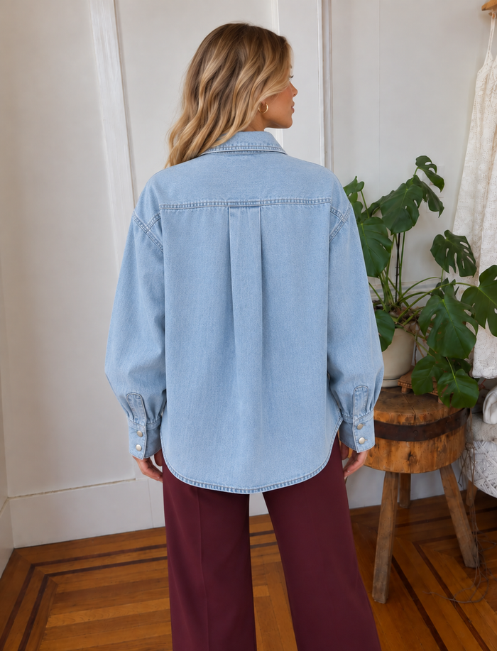 Back view of Merritt Osalina light wash denim shacket with center pleat and curved hem